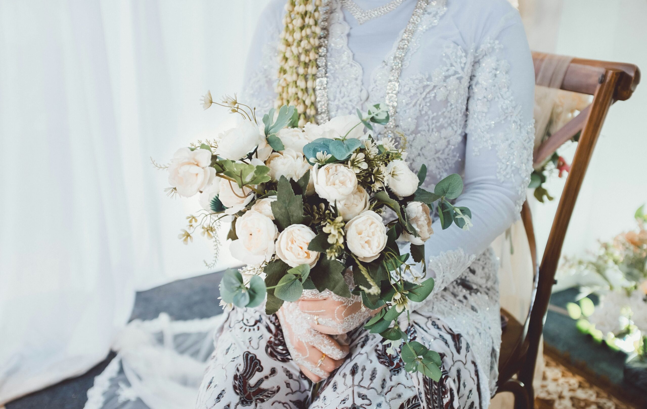 A bride in a lace dress with a sleek braided updo