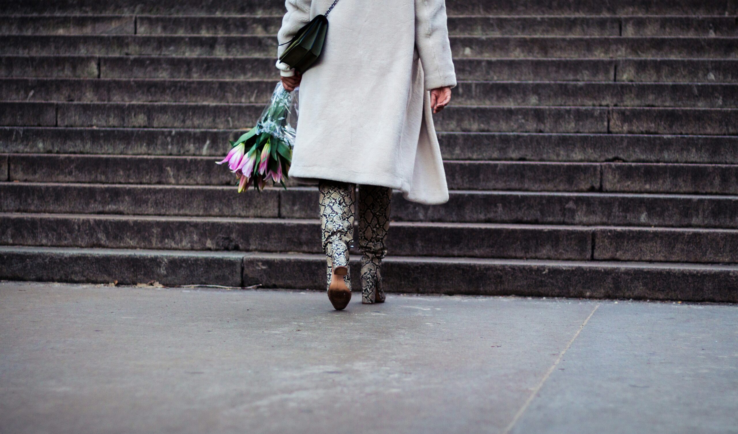 A chic woman walking down the red carpet with a sleek low bun adorned with sparkly pins