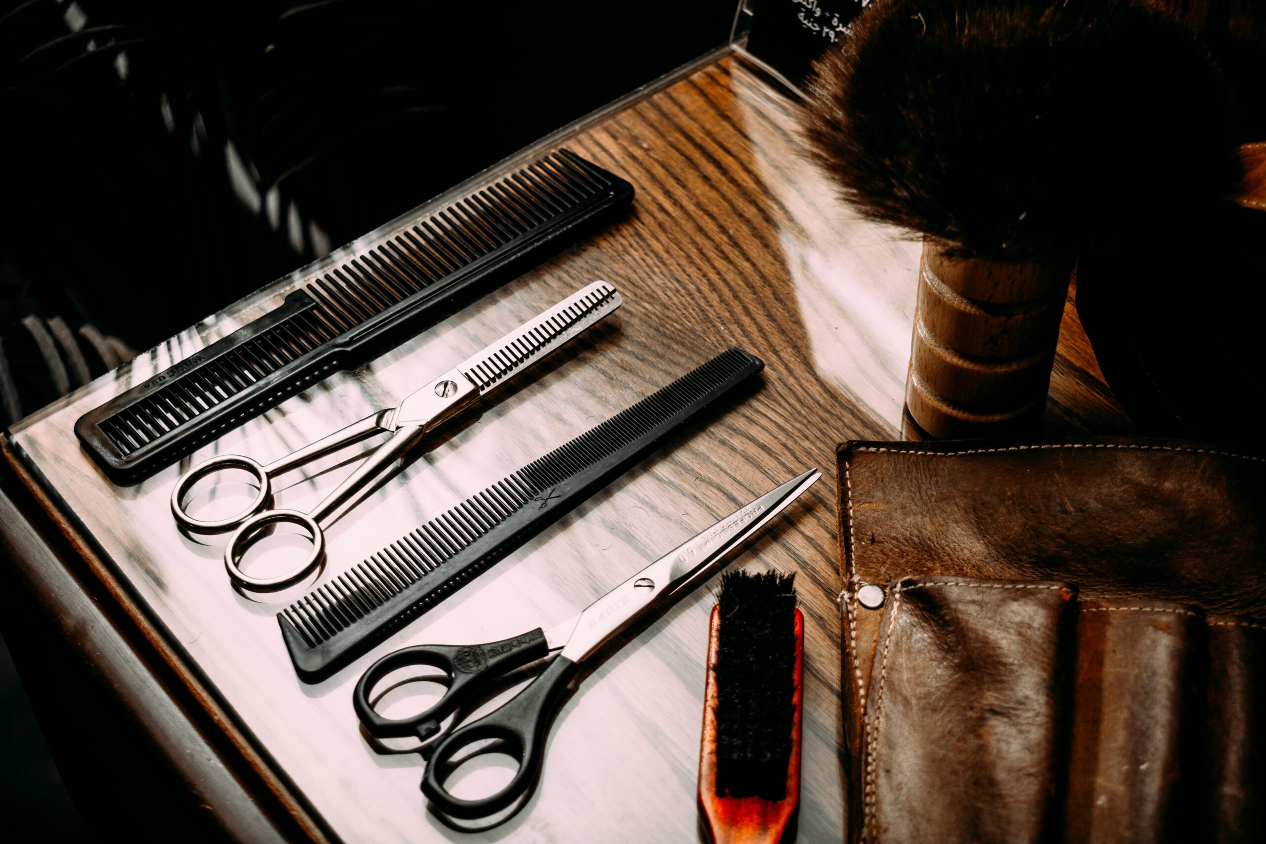 Closeup of professional hairstyling tools including combs, brushes, and clips