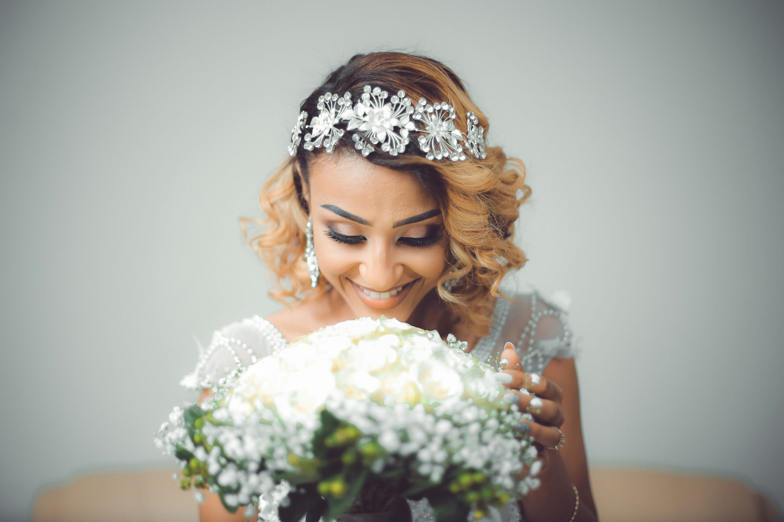 Wedding guest wearing pearl pins in her elegant low bun hairstyle