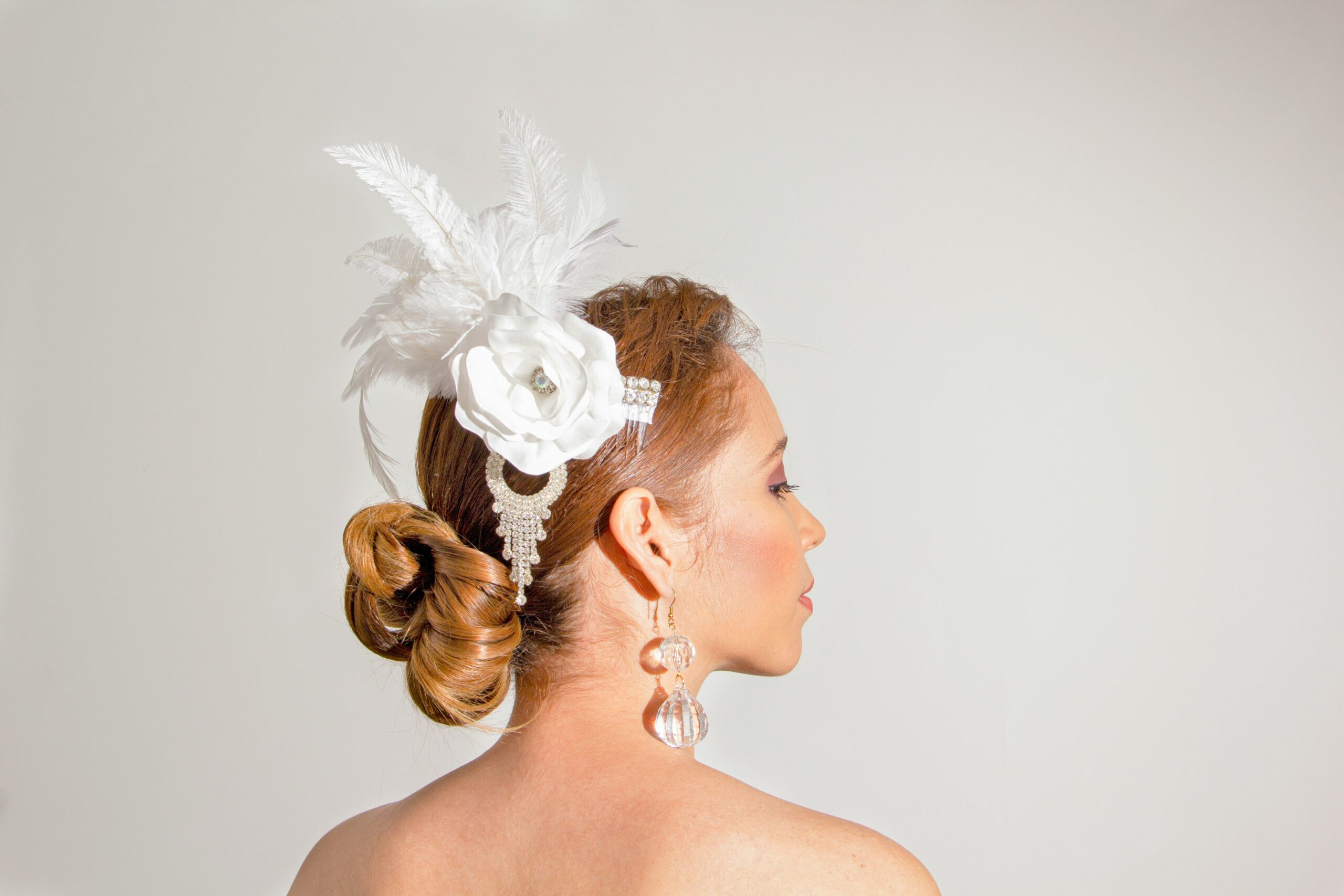 A close-up image of elegant bridal hair accessories such as pearl pins, metallic headbands, and floral crowns.