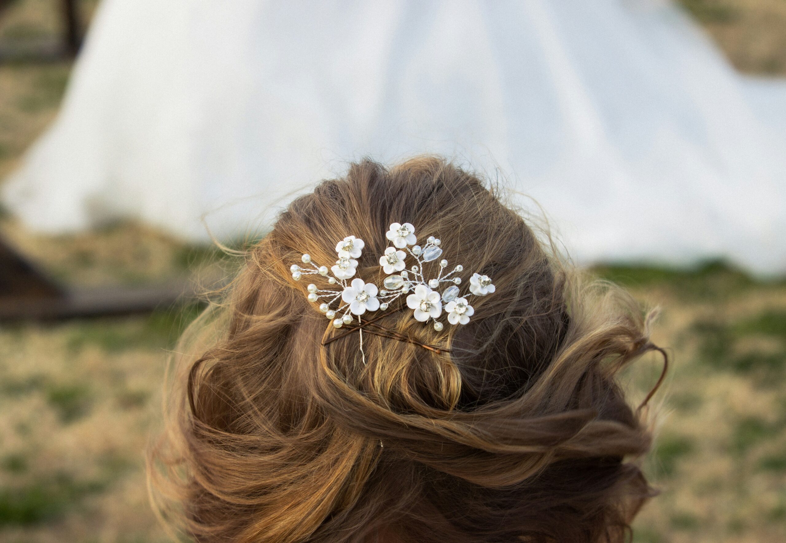 Close-up shot of someone applying styling mousse to damp hair