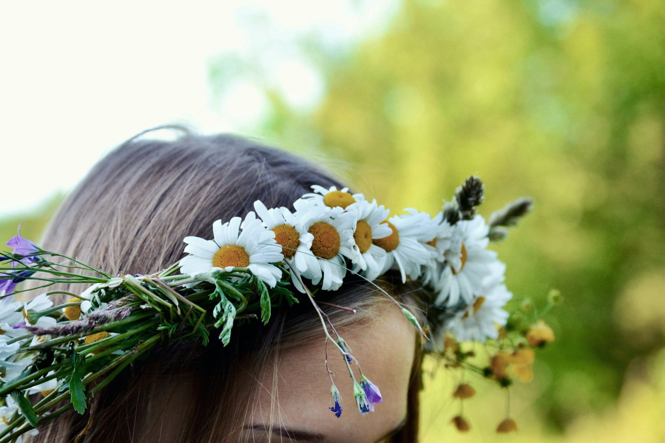 Hairstylist adjusting decorative combs in a bride's intricate updo