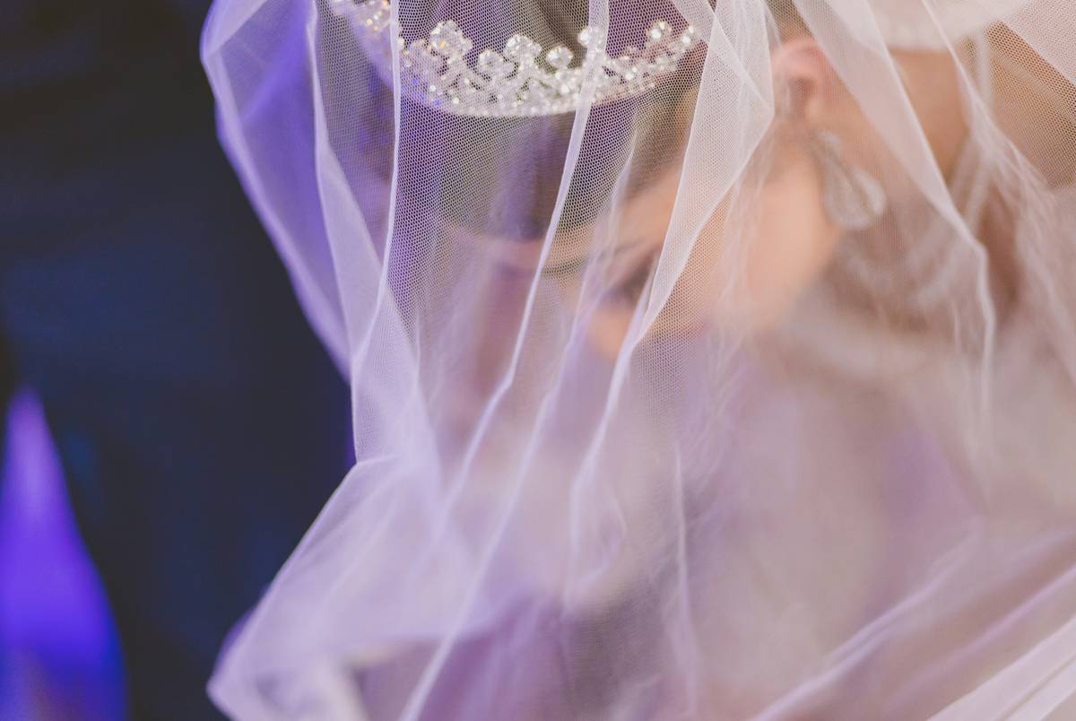 Bride fixing messy updo after attempting DIY hairstyle