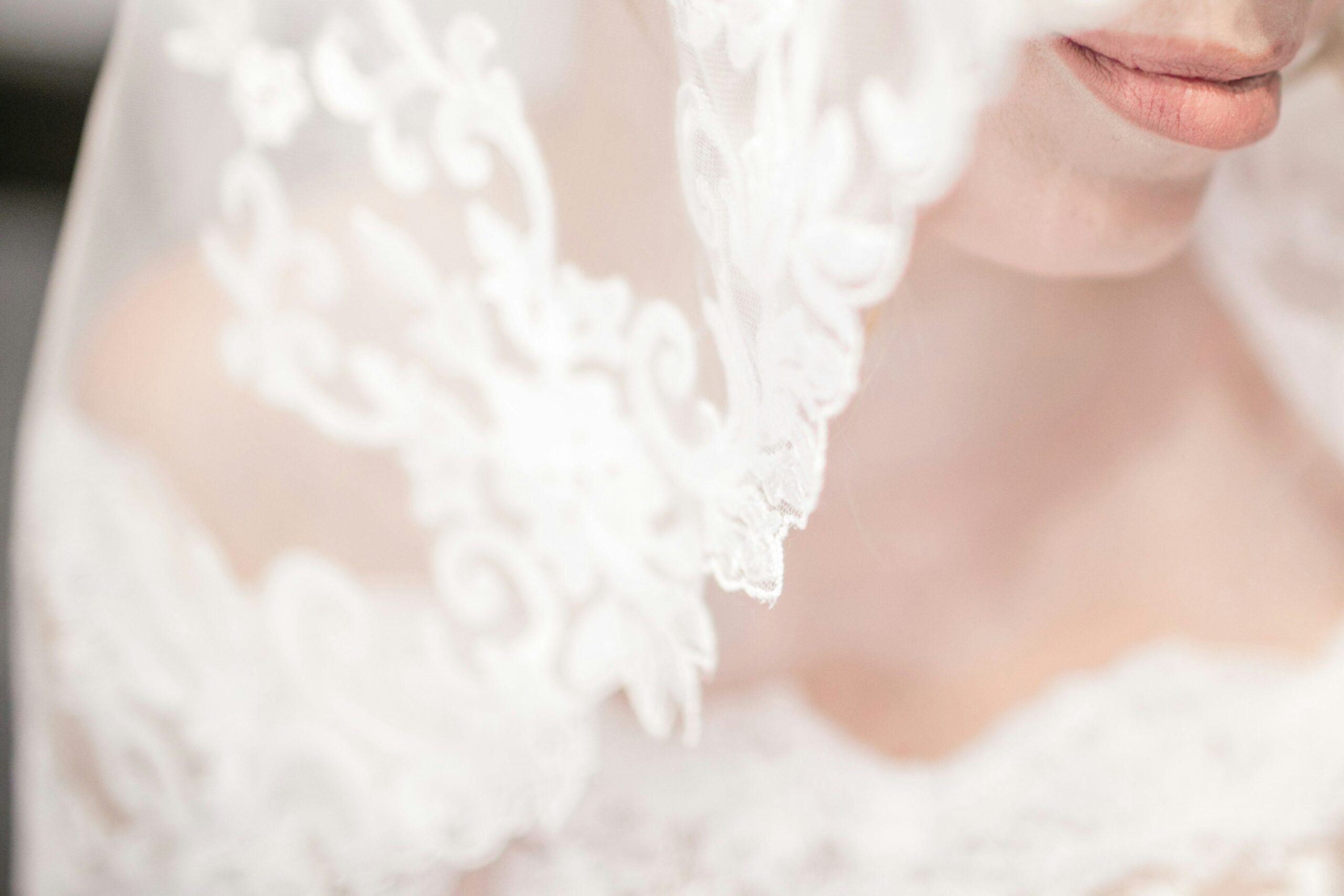 Hair stylist adding finishing touches to a romantic bridal updo