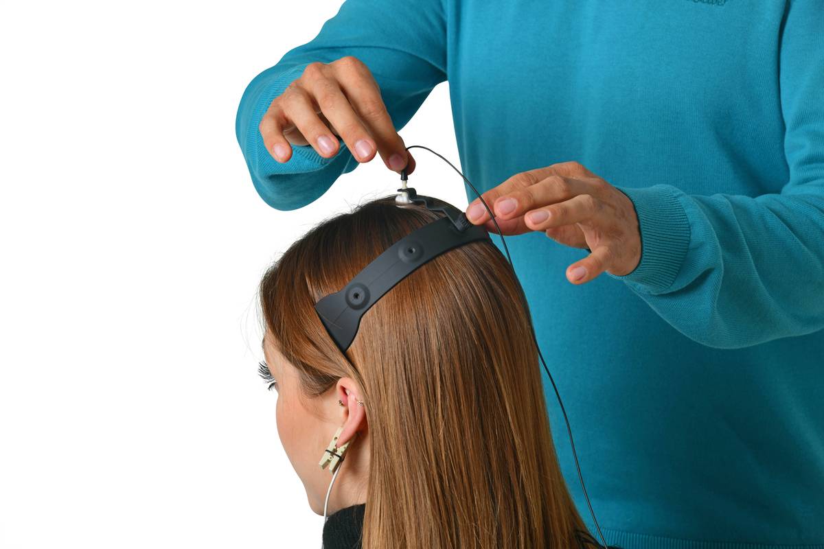 Woman blow-drying her blonde hair after applying volumizing mousse
