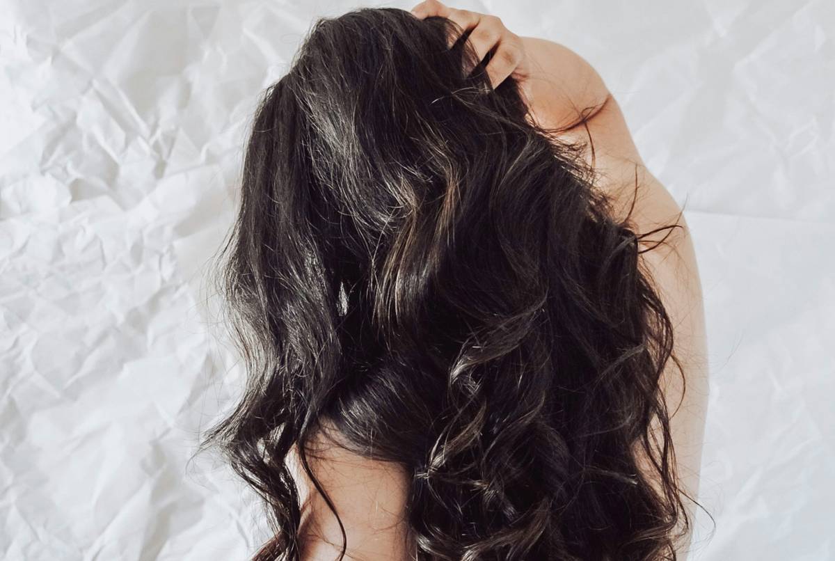 A sleek set of hairpins, bobby pins, and scrunchies on a marble countertop.