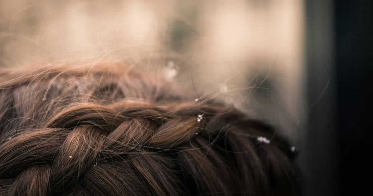 A woman confidently showing off her elegant updo hairstyle