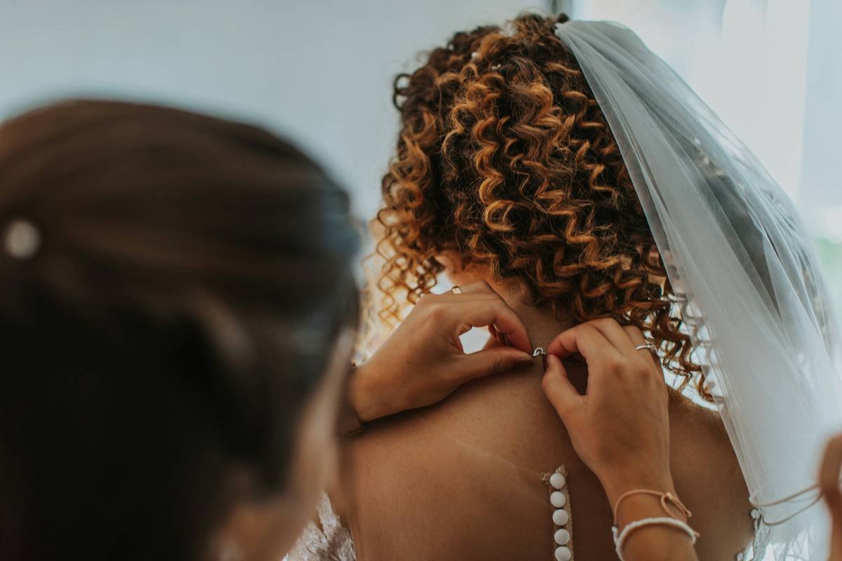 Bride getting her hair styled by a professional stylist