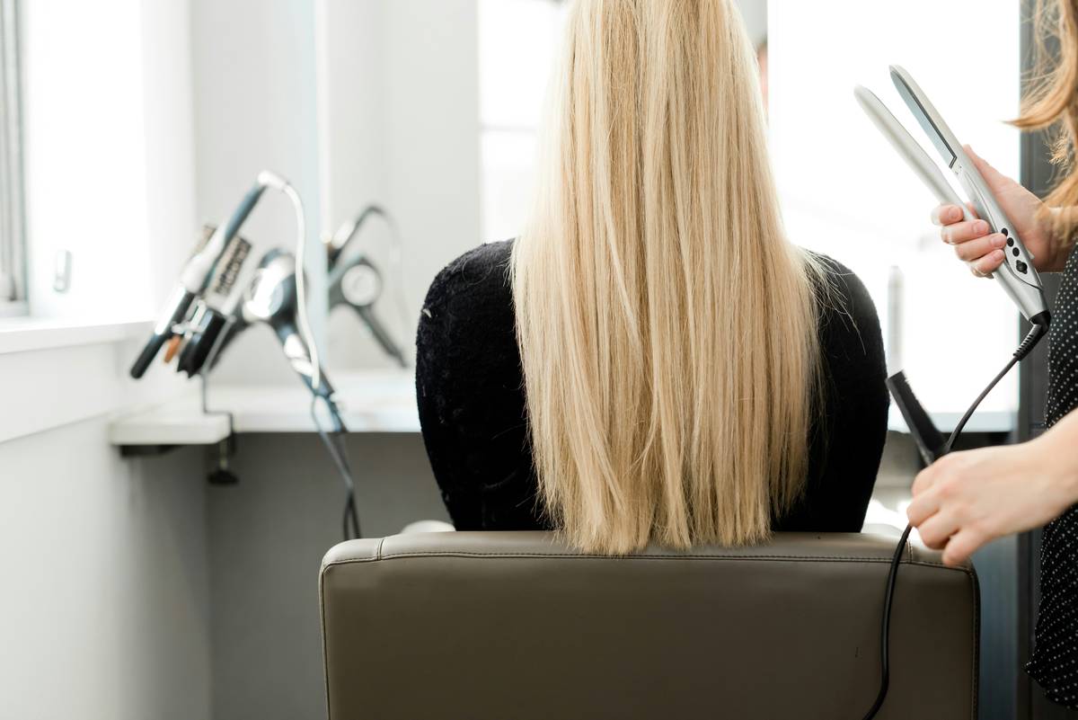 Two women showcasing their office-friendly updos in a professional setting