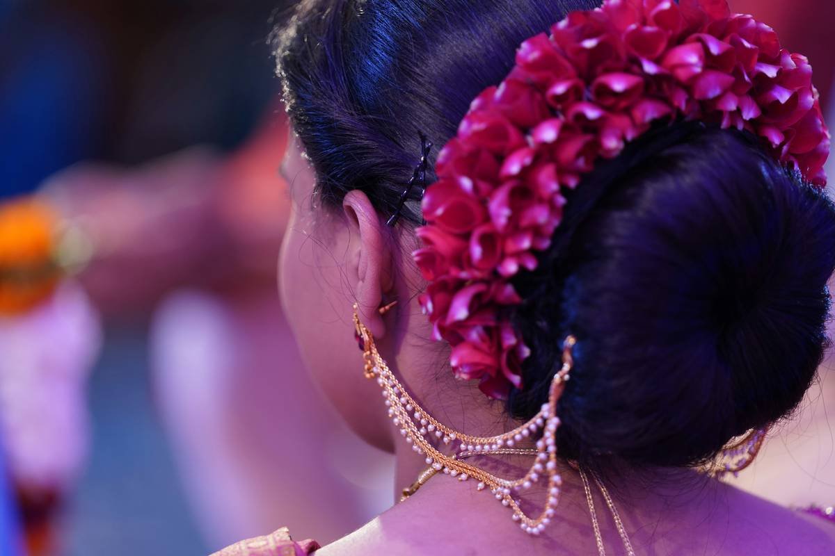A bride with an elegant braided updo adorned with pearls
