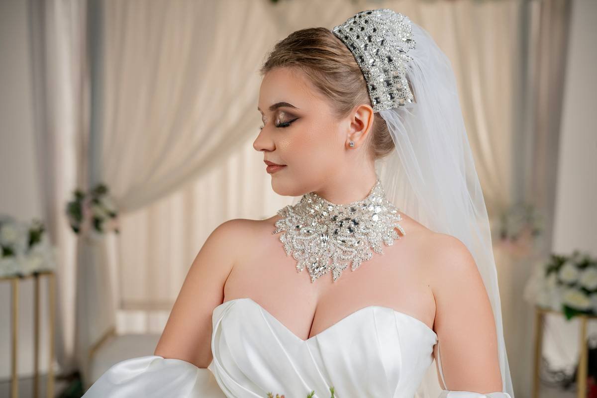 A bride wearing a classic low bun adorned with pearl hairpins, showcasing bridal hair glamour.