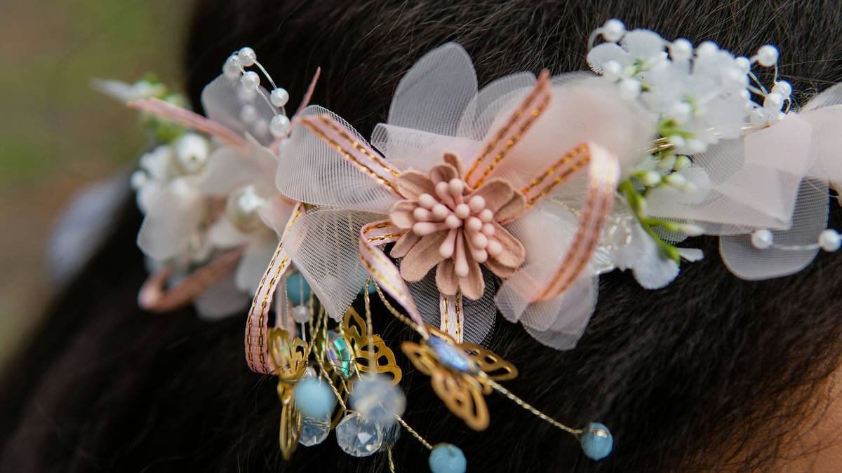 A bride wearing a romantic updo with floral accessories